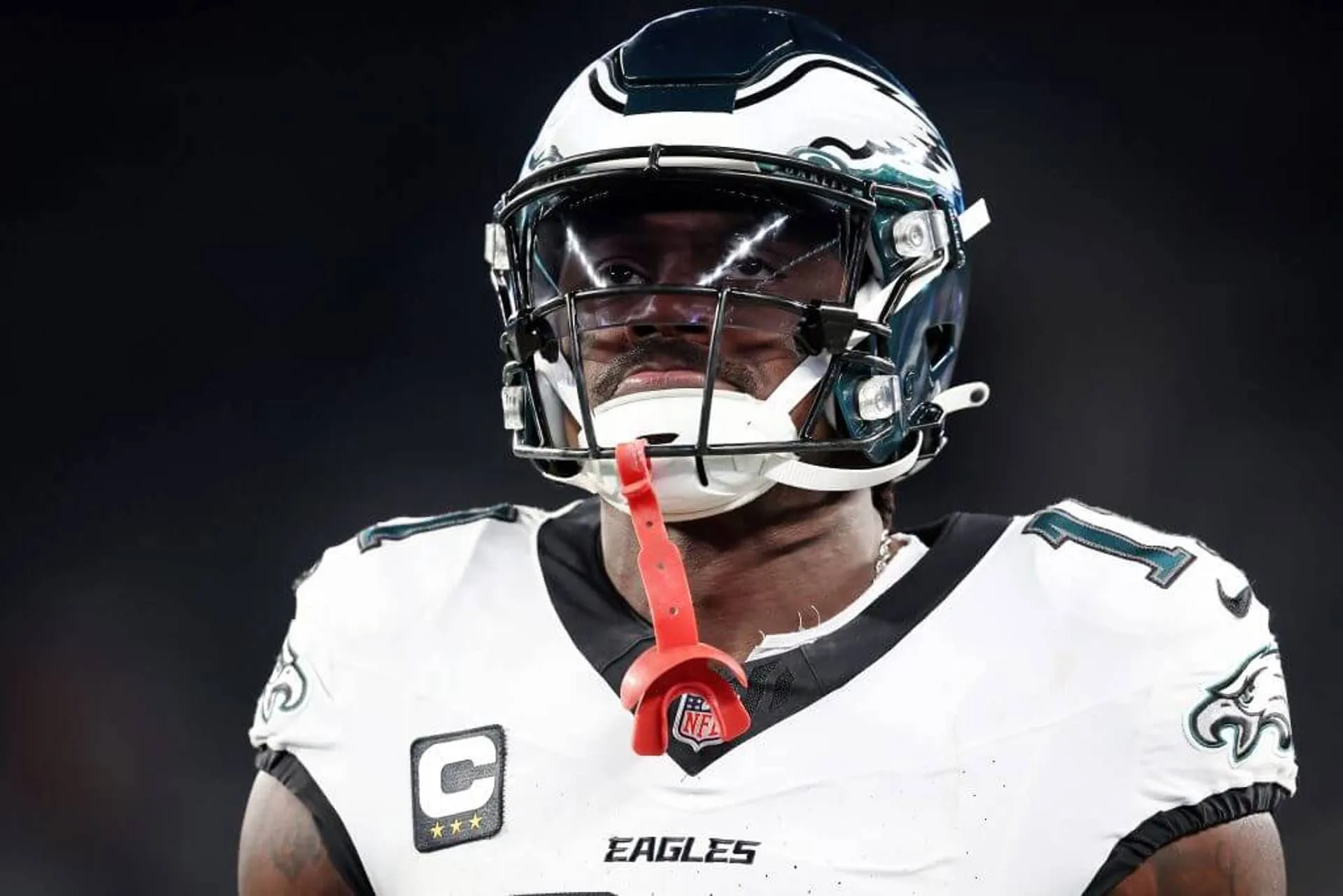 Philadelphia Eagles wide receiver A.J. Brown wearing a helmet and a white jersey with his red mouthguard sticking out.