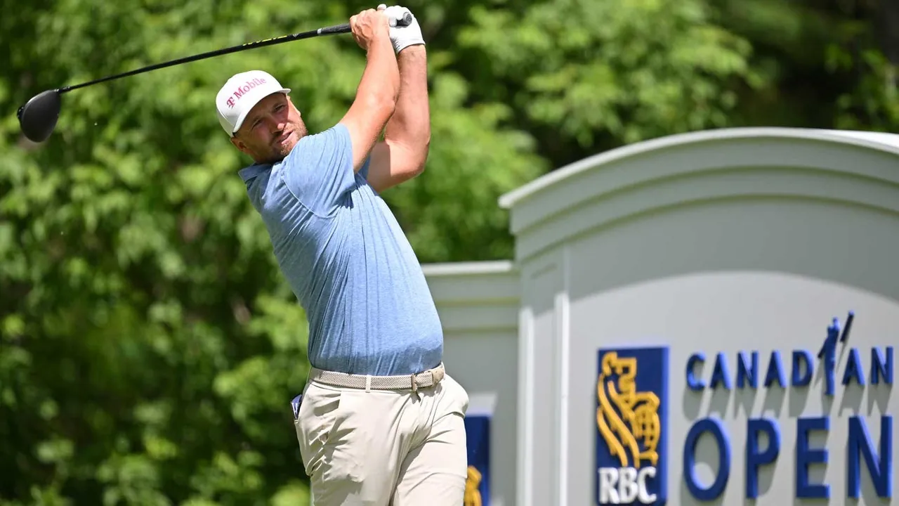 A golfer in a blue shirt and white cap swings a club on the course, with a sign for the RBC Canadian Open in the background, surrounded by greenery—capturing excitement ahead of the 2026 RBC Canadian Open Sunday tee times.