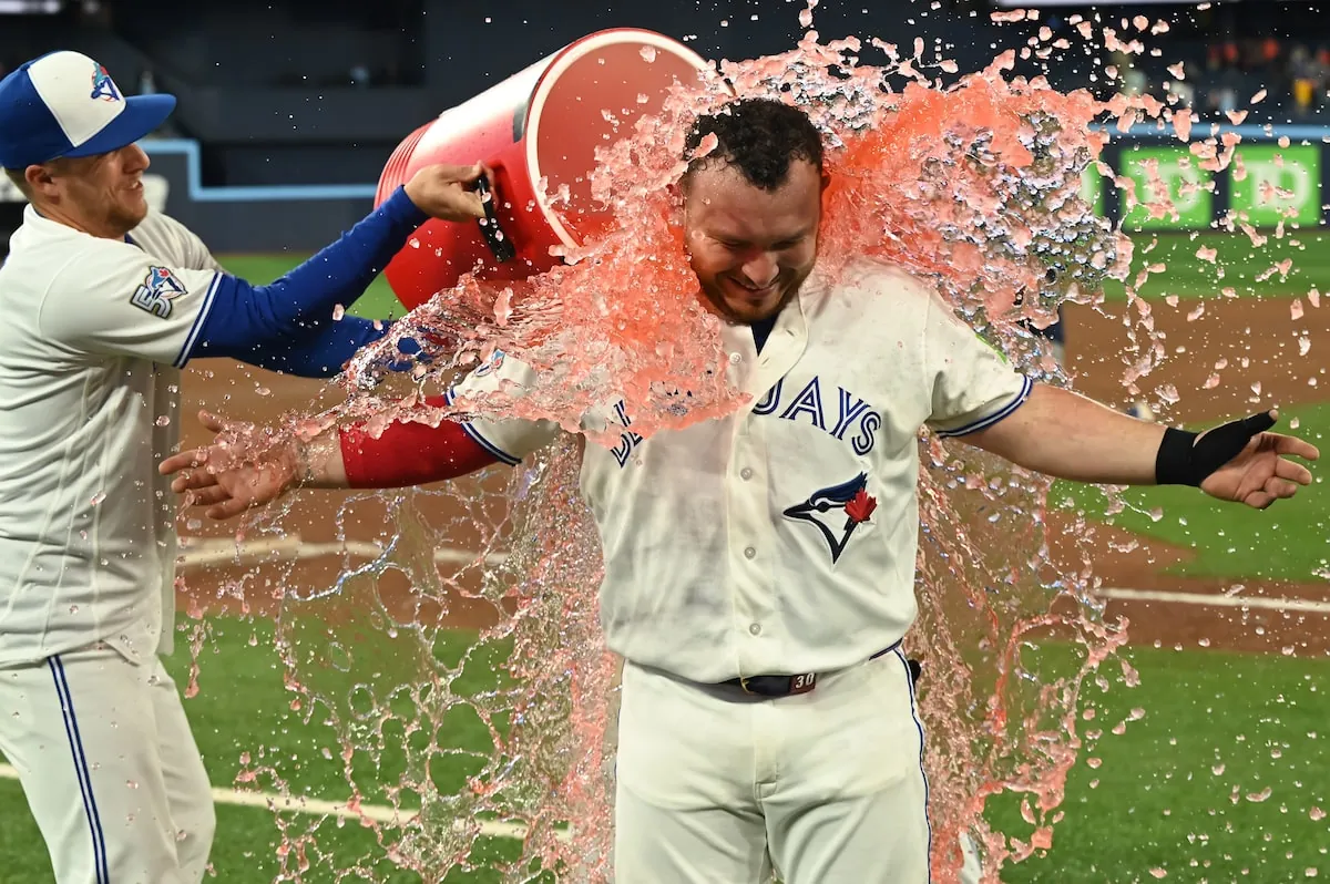 Toronto Blue Jays outfielder Myles Straw, left, douses Jays' catcher Alejandro Kirk with sports drink to celebrate their team's victory over the Houston Astros in MLB baseball action in Toronto.Jon Blacker/The Canadian Press